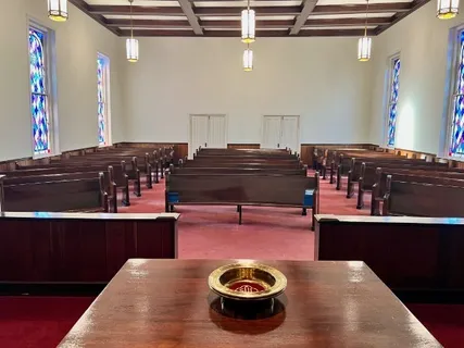 a living room with table chairs and wooden floor