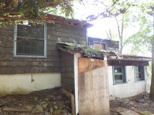 a view of a brick house with a small yard