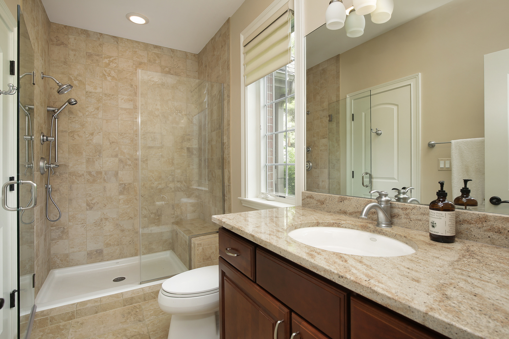 10309 Lawrence Road Harvard, IL 60033 - Photo 29 of 56 a bathroom with a granite countertop sink a toilet a mirror and shower