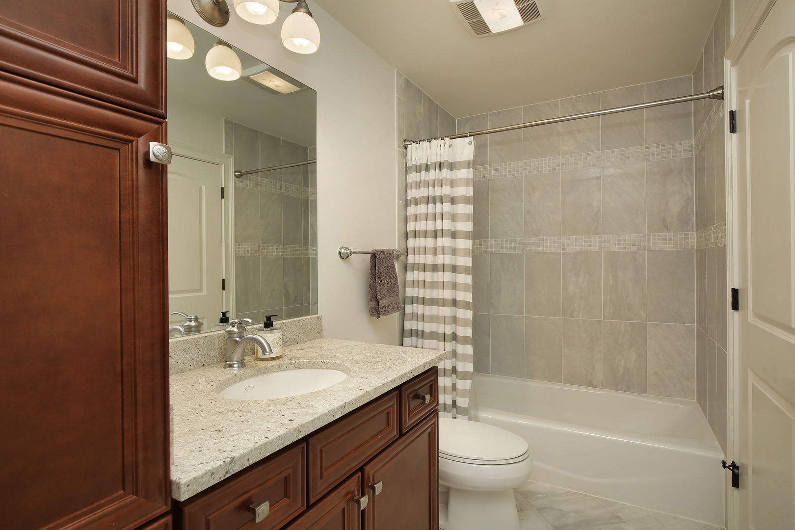 10309 Lawrence Road Harvard, IL 60033 - Photo 35 of 56 a bathroom with a granite countertop sink toilet and shower