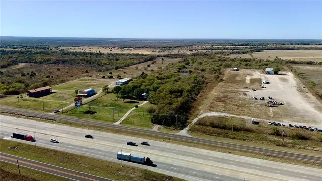 a view of a field with an ocean view