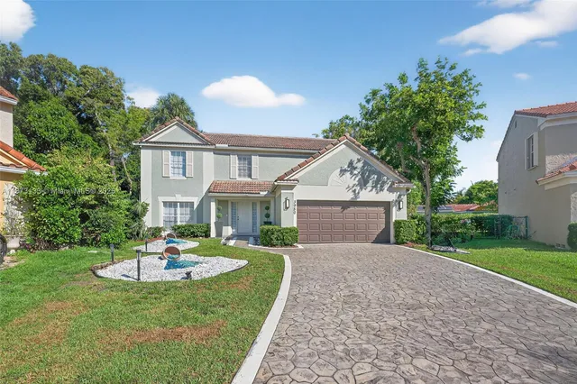 a front view of a house with a yard and garage