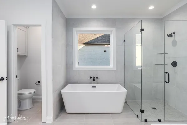 a spacious bathroom with a shower sink and a mirror