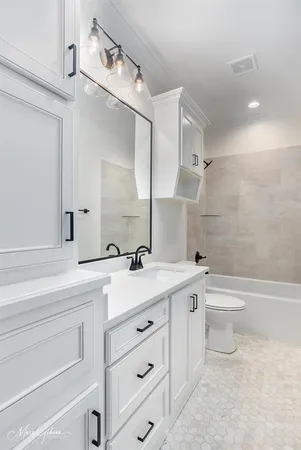 a white bath tub sitting next to a white toilet