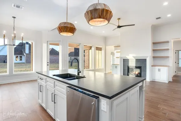 a kitchen with a table chairs and a chandelier