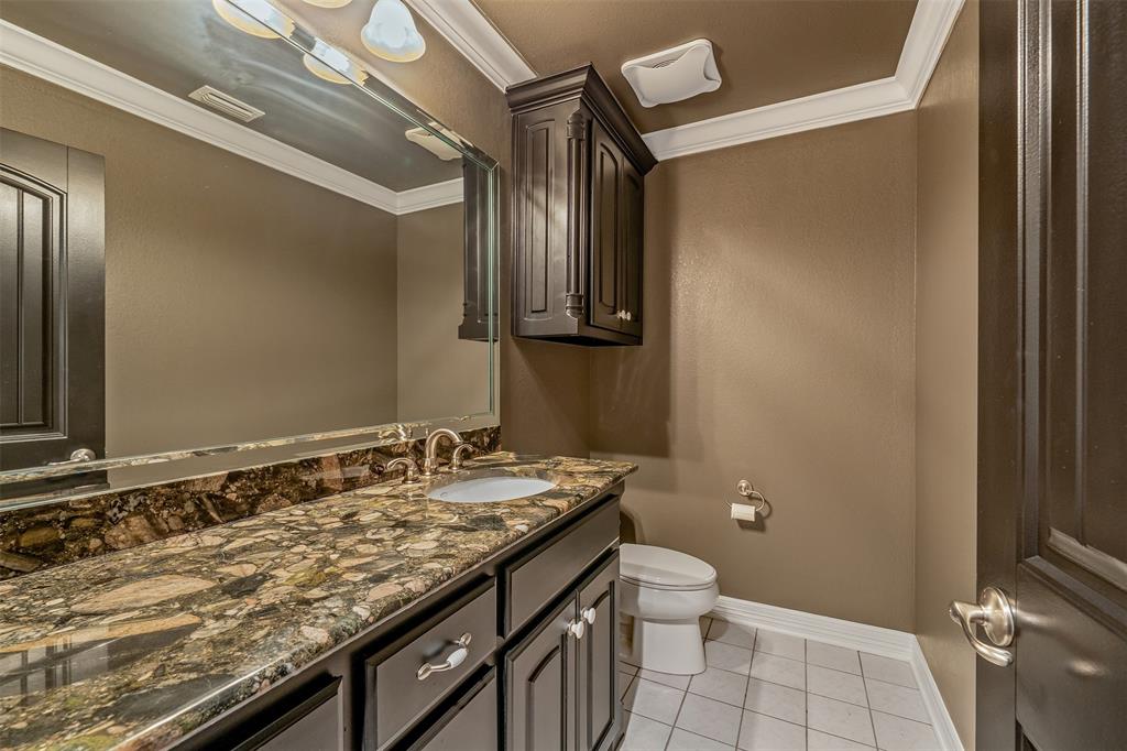 20389 County Road 178 Flint, TX 75762 - Photo 31 of 40 Vanity area featuring a stone countertop with an undermount sink, dark wood cabinetry, and a full-width mirror