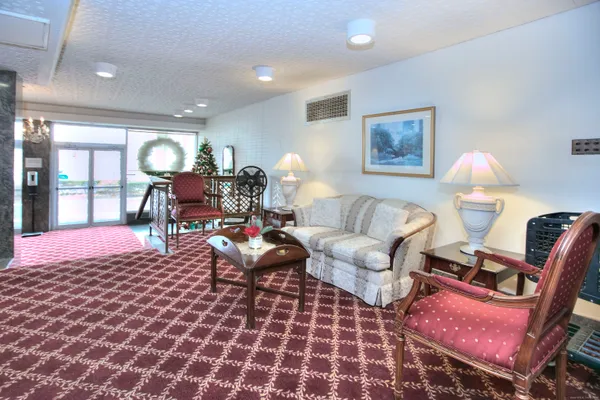 a living room with a couch and a chandelier