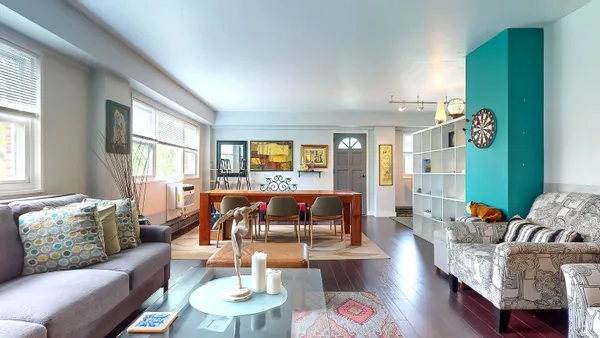 a living room with furniture and a wooden floor