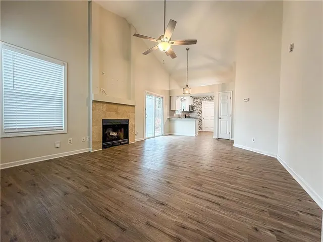 a view of empty room with wooden floor and fireplace
