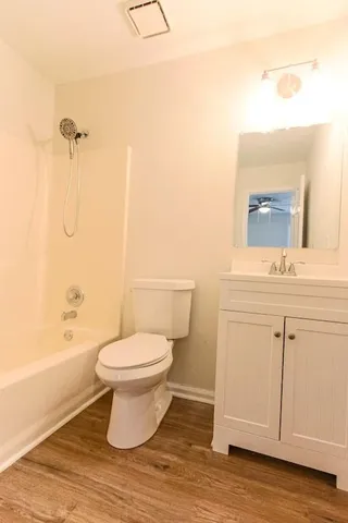 a bathroom with a toilet a sink and bathtub