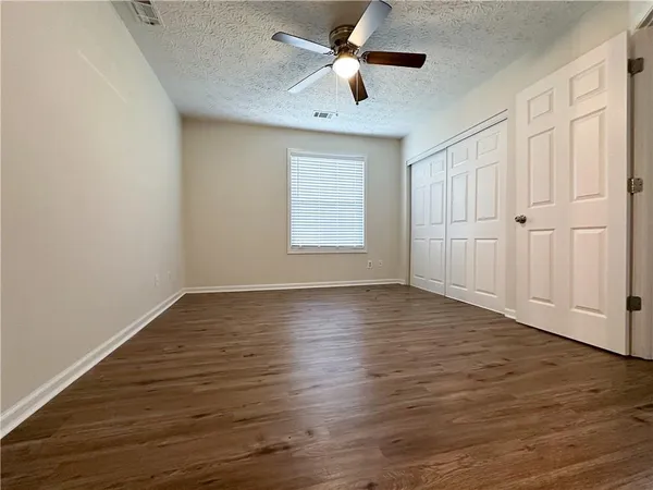 a spacious bathroom with a double vanity sink toilet and shower