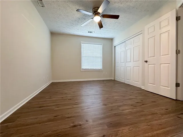 a spacious bathroom with a double vanity sink toilet and shower