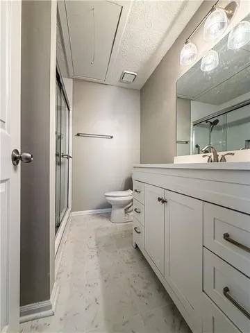 a bathroom with a toilet and a shower