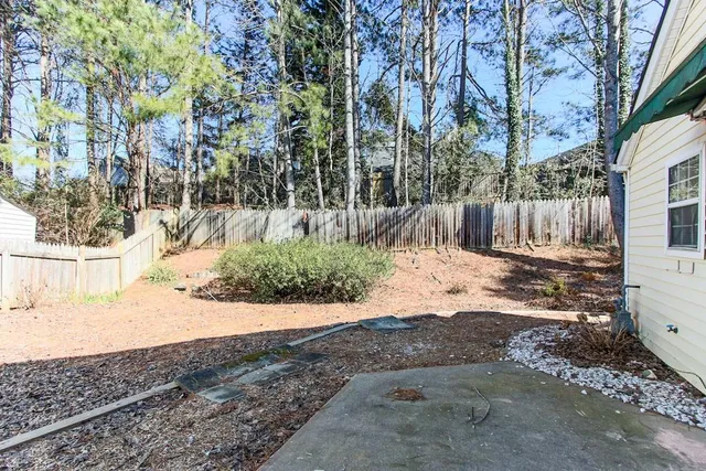 a view of a backyard with large trees
