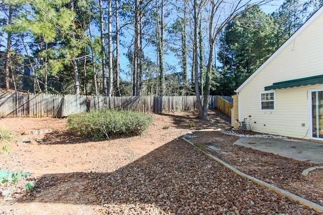 a view of a backyard with large trees