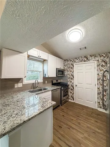 a view of a backyard with large trees