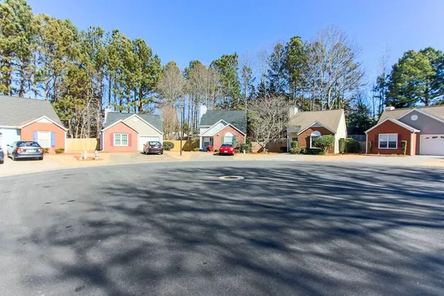 a kitchen with a refrigerator sink and cabinets