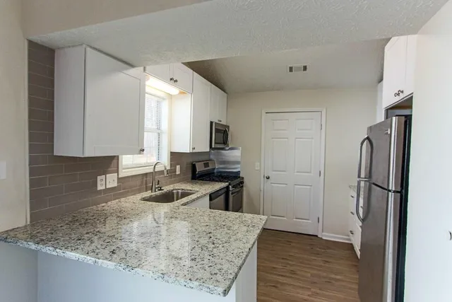 a kitchen with a refrigerator sink and refrigerator