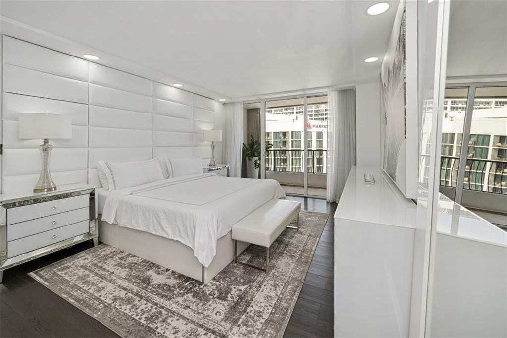 555 Northeast 15th Street, Unit 32C Miami, FL 33132 - Photo 13 of 21 a bedroom with a bed and wooden floor