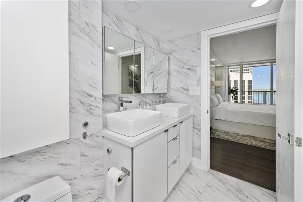 555 Northeast 15th Street, Unit 32C Miami, FL 33132 - Photo 14 of 21 a bathroom with a sink and a mirror