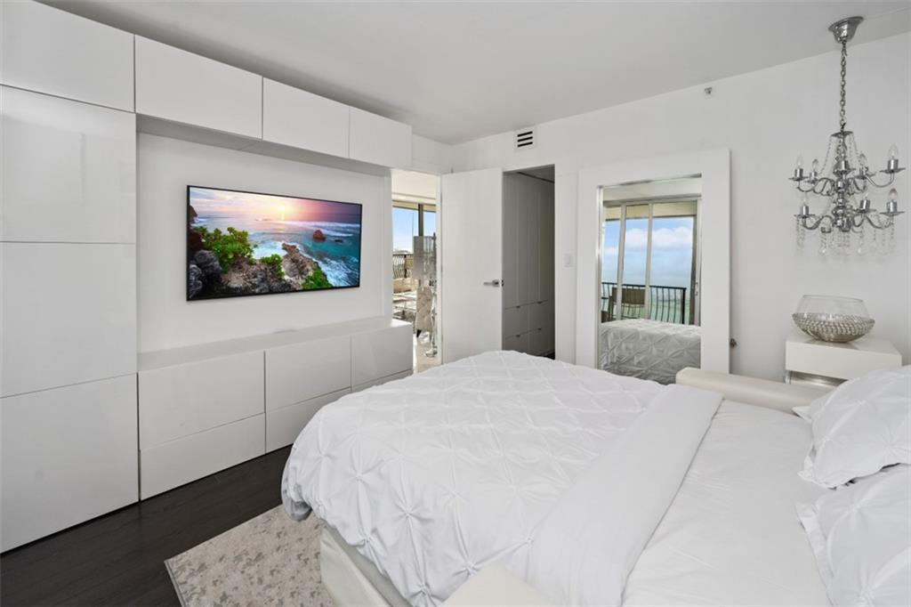 555 Northeast 15th Street, Unit 32C Miami, FL 33132 - Photo 17 of 21 a bedroom with a bed and a flat screen tv