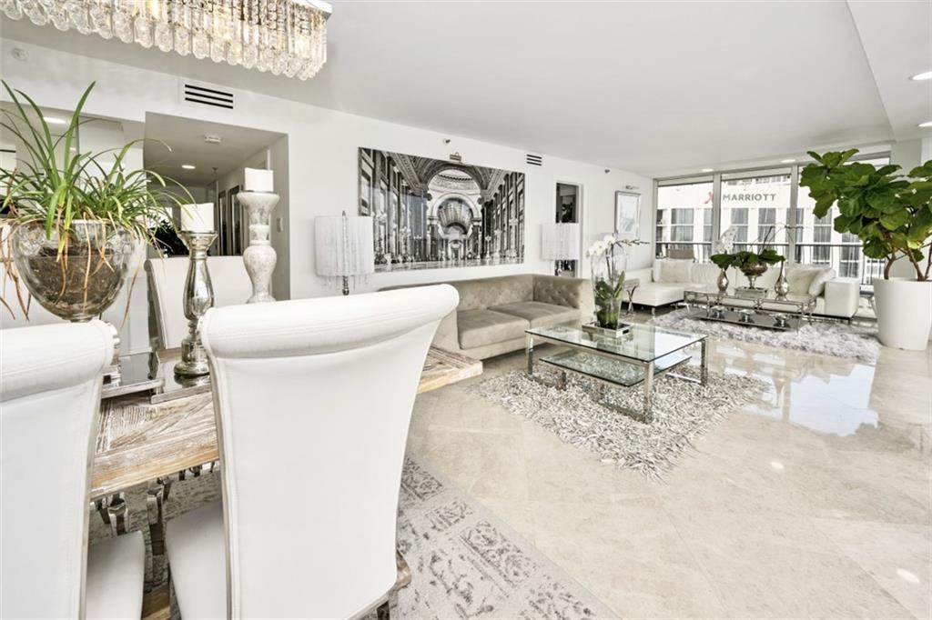 555 Northeast 15th Street, Unit 32C Miami, FL 33132 - Photo 7 of 21 a living room with furniture and a large window