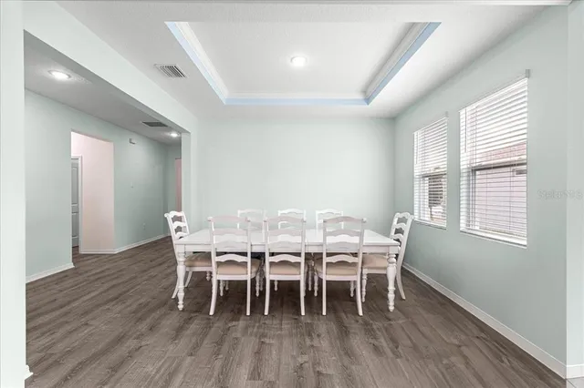 a view of a dining room with furniture and wooden floor