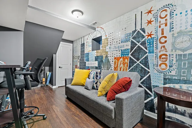 a living room with patio furniture and a wooden floor