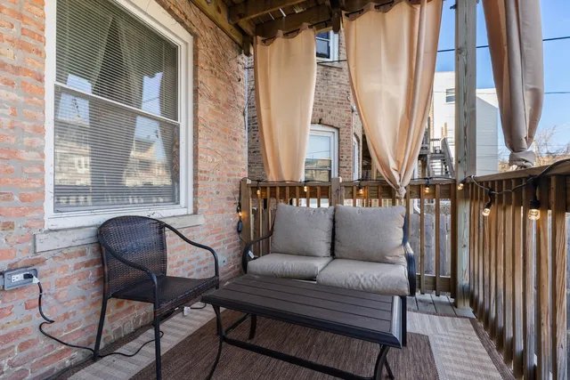 a living room with fireplace furniture and a window