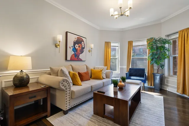 a living room with furniture and a lamp