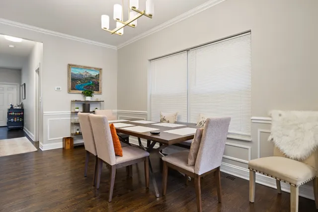 a view of a dining room with furniture wooden floor and chandelier