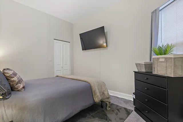 a bedroom with a bed and a potted plant