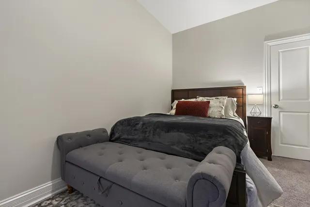 a bedroom with a bed and with chair