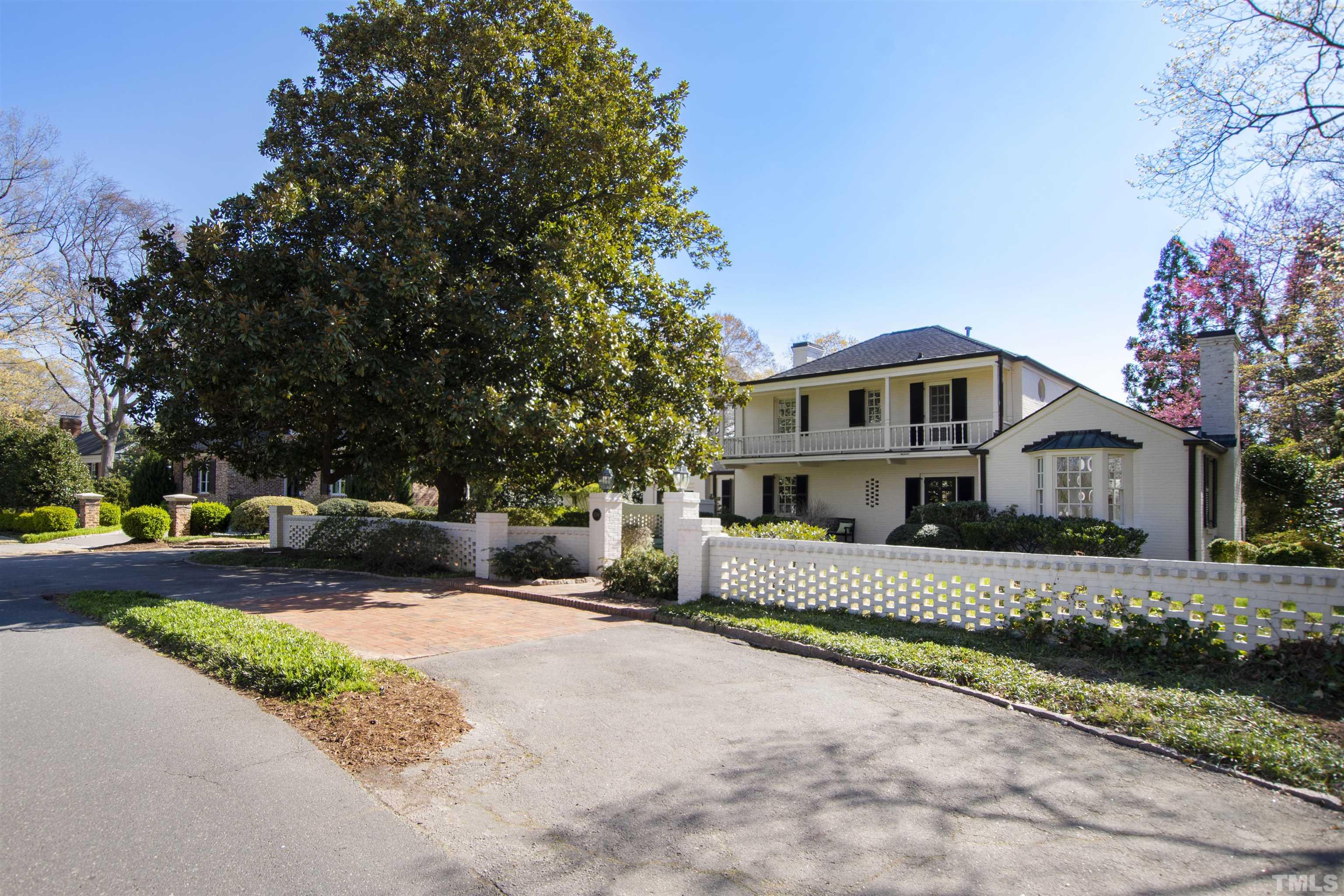 a front view of a house with a yard and trees