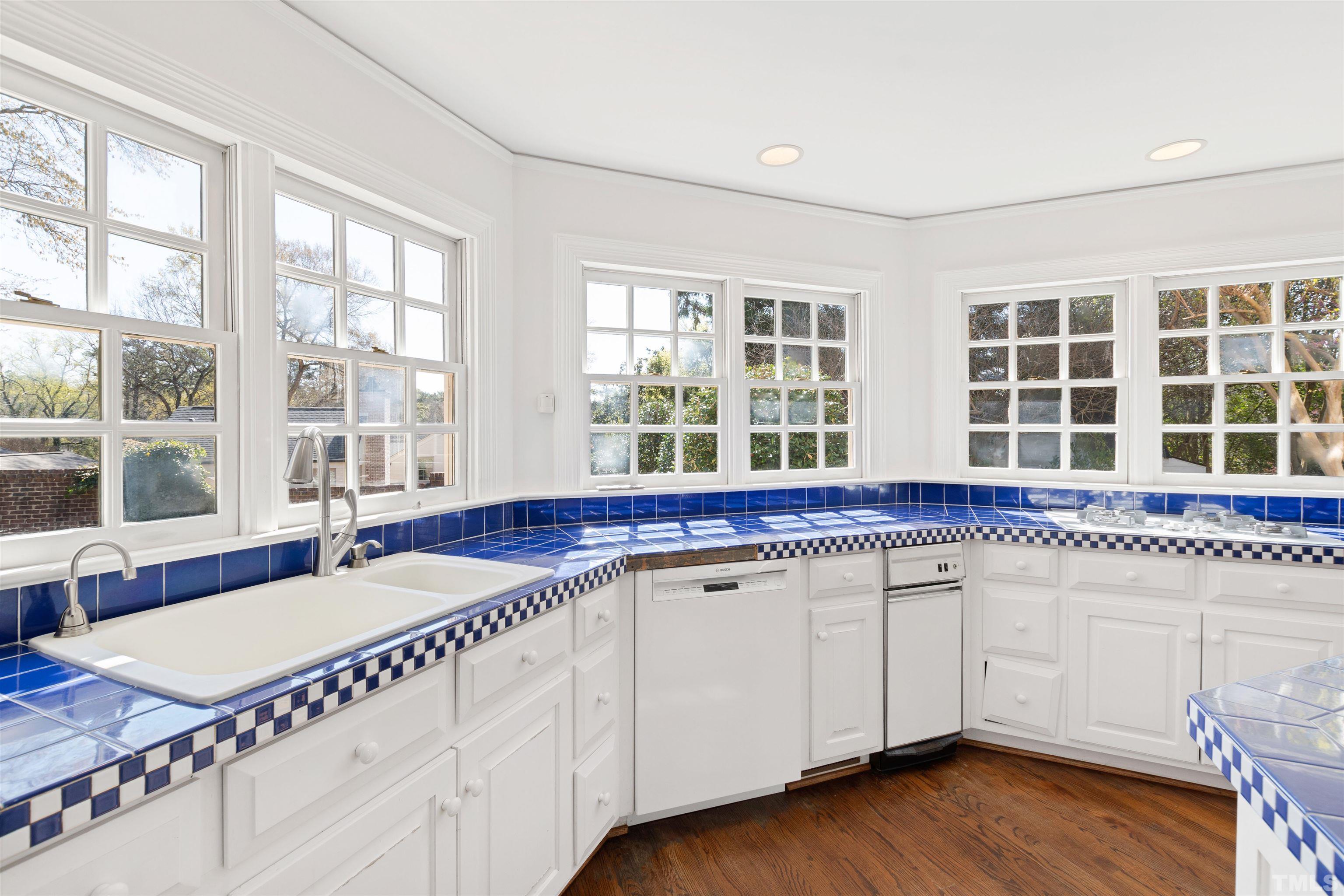 1718 Canterbury Road Raleigh, NC 27608 - Photo 14 of 30 a kitchen with granite countertop a stove a sink and a wooden floors