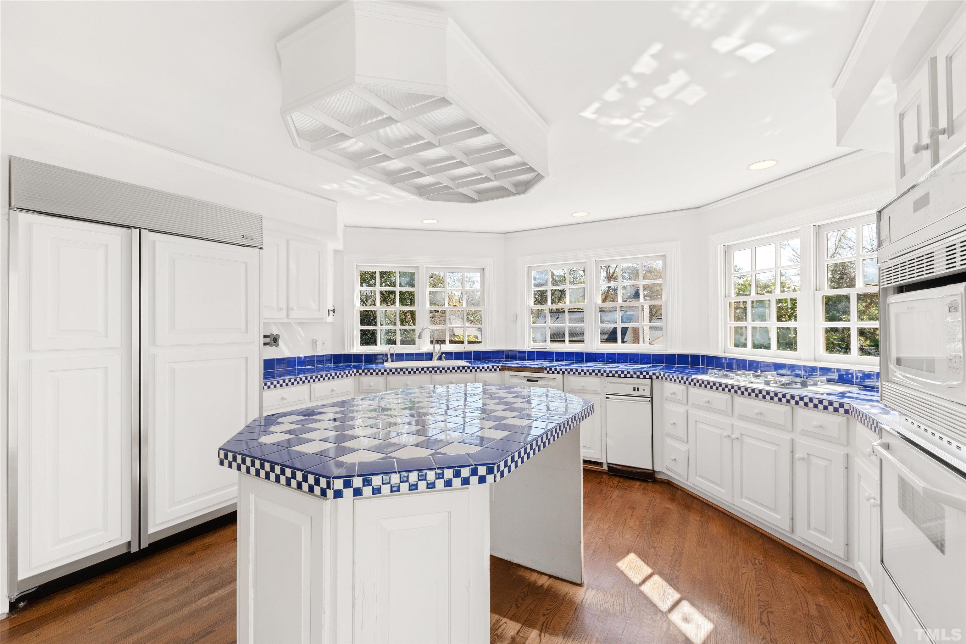 1718 Canterbury Road Raleigh, NC 27608 - Photo 15 of 30 a kitchen with stainless steel appliances granite countertop a sink dishwasher and cabinets with wooden floor