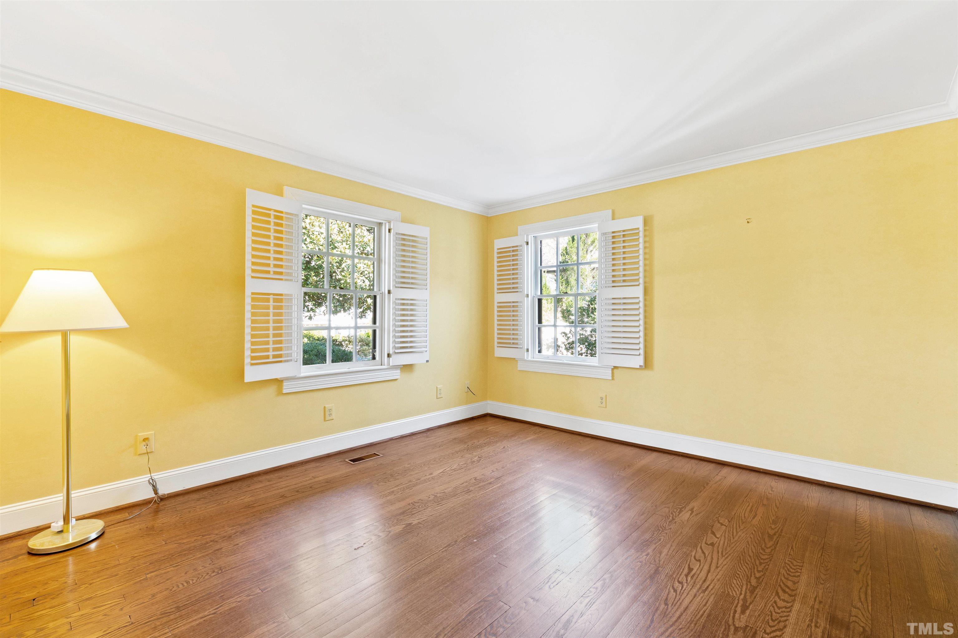 1718 Canterbury Road Raleigh, NC 27608 - Photo 17 of 30 a view of an empty room with wooden floor and a window