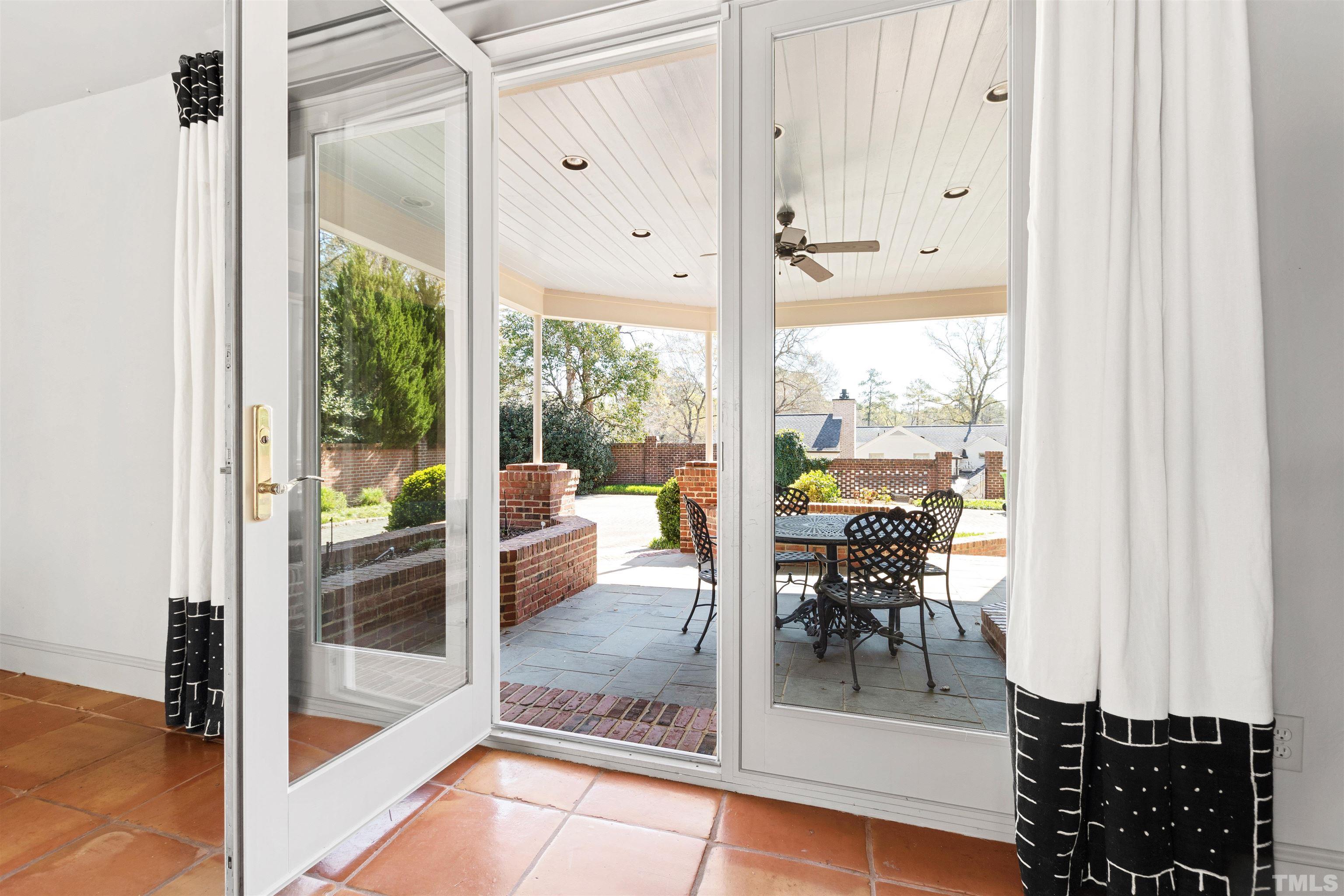 1718 Canterbury Road Raleigh, NC 27608 - Photo 20 of 30 a dining room with furniture and a floor to ceiling window