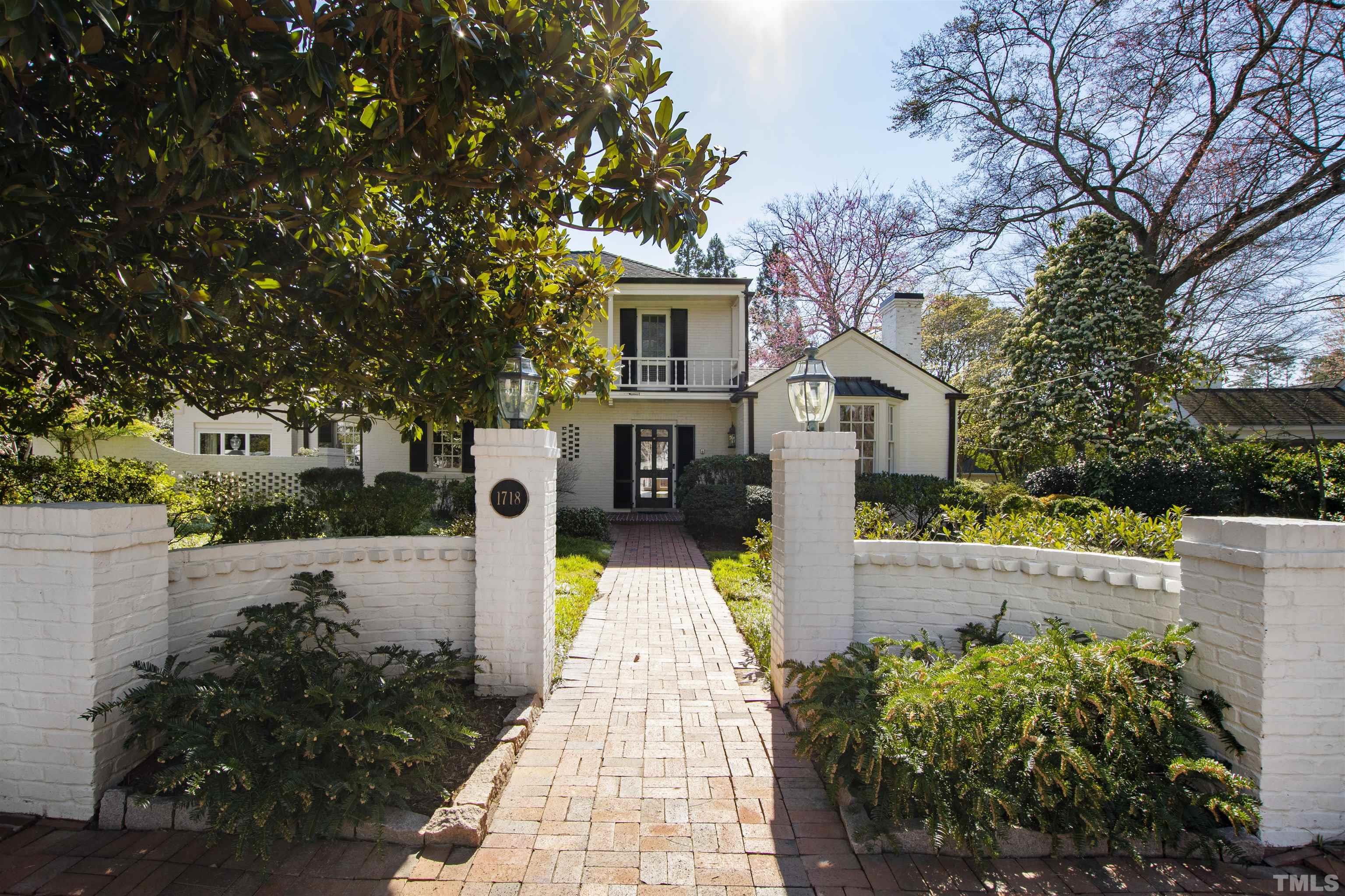 1718 Canterbury Road Raleigh, NC 27608 - Photo 2 of 30 a front view of a house with a yard and fountain