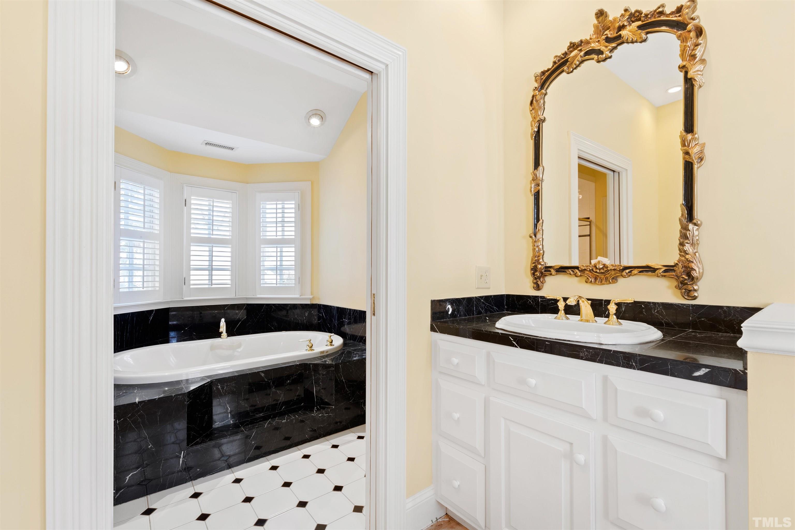 1718 Canterbury Road Raleigh, NC 27608 - Photo 25 of 30 a bathroom with a sink and a mirror