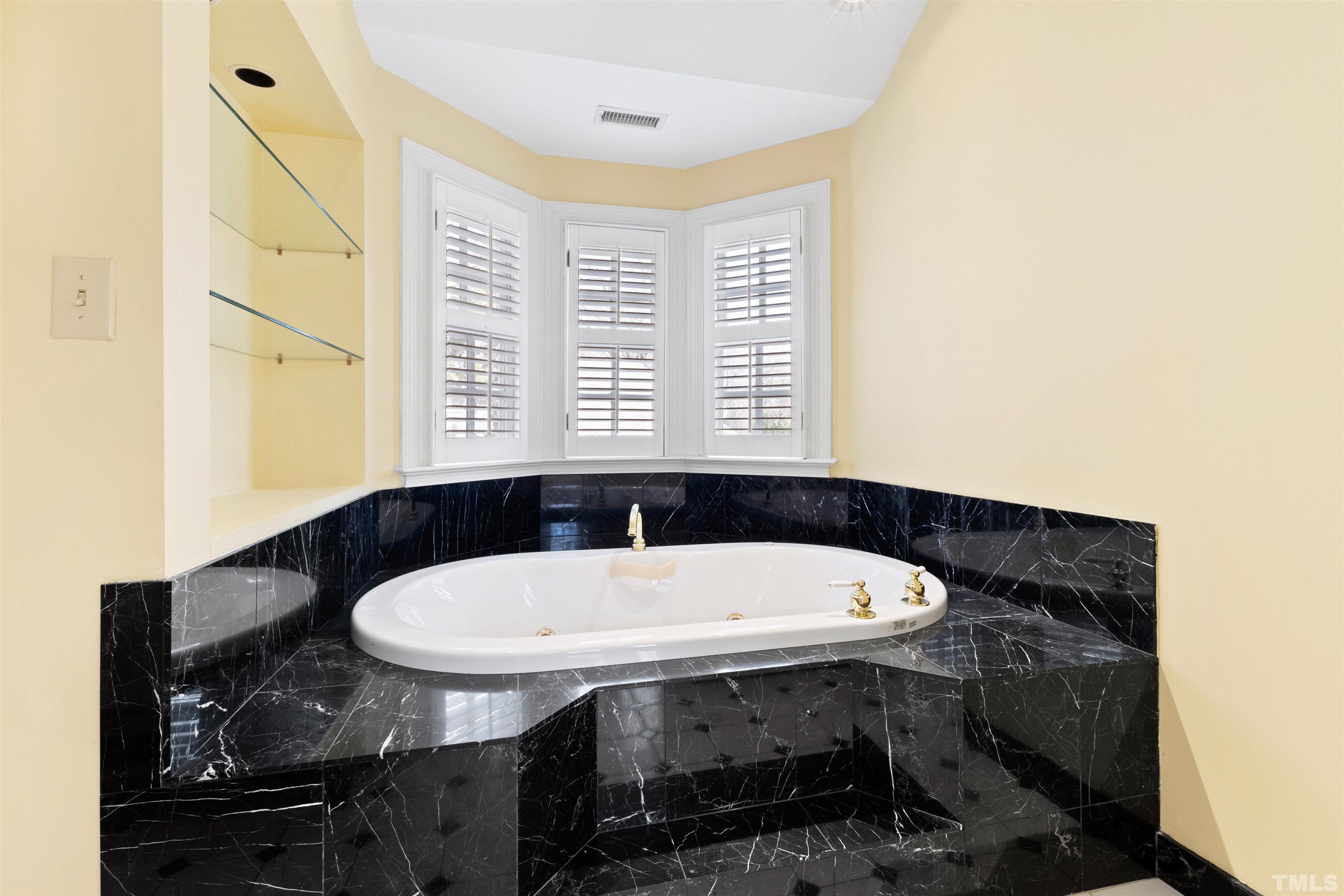 1718 Canterbury Road Raleigh, NC 27608 - Photo 26 of 30 a bathroom with a sink and a bathtub