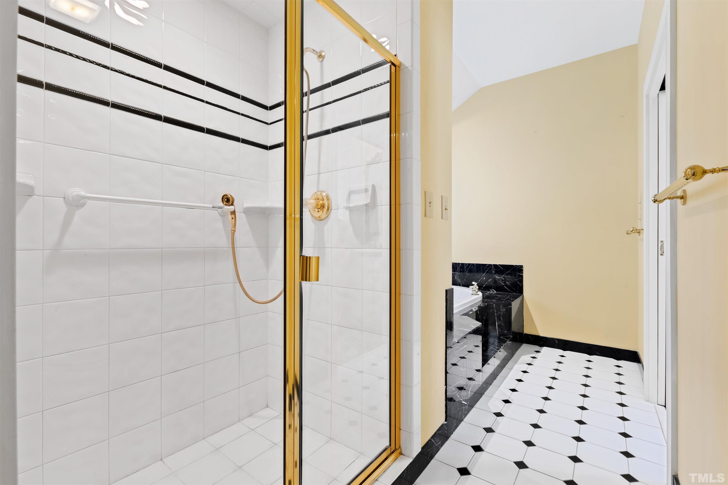 1718 Canterbury Road Raleigh, NC 27608 - Photo 27 of 30 a walk in closet and bathroom with a shower