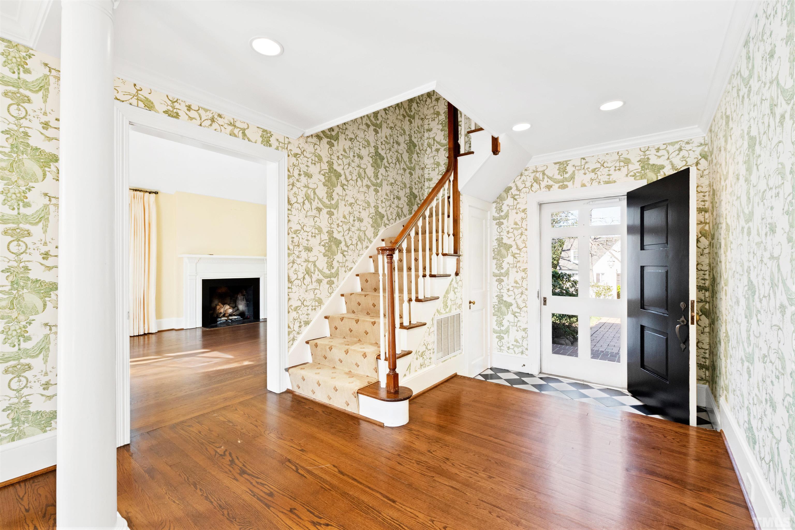 1718 Canterbury Road Raleigh, NC 27608 - Photo 9 of 30 a view of a livingroom with wooden floor and a fireplace