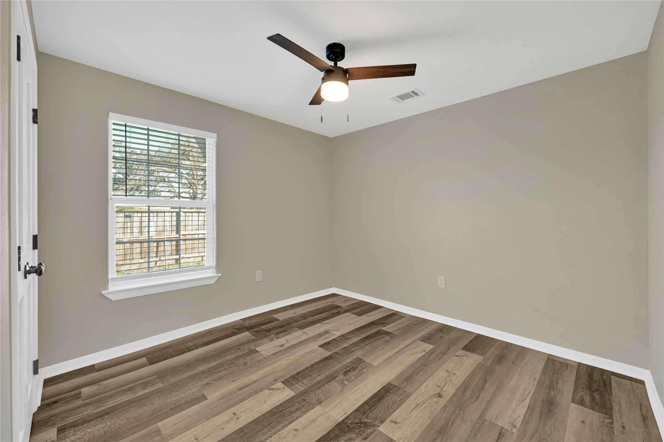 7814 Avenue F Houston, TX 77012 - Photo 20 of 28 a view of a room with wooden floor and a ceiling fan