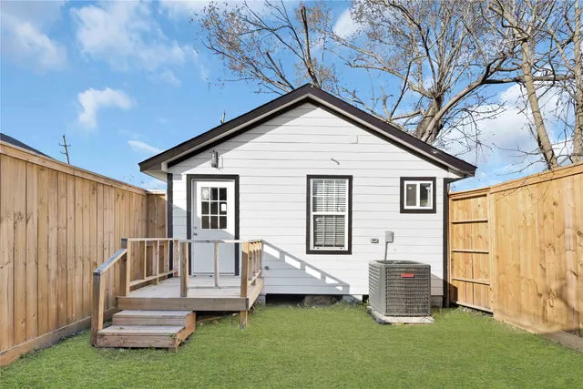 a front view of a house with a garden and yard