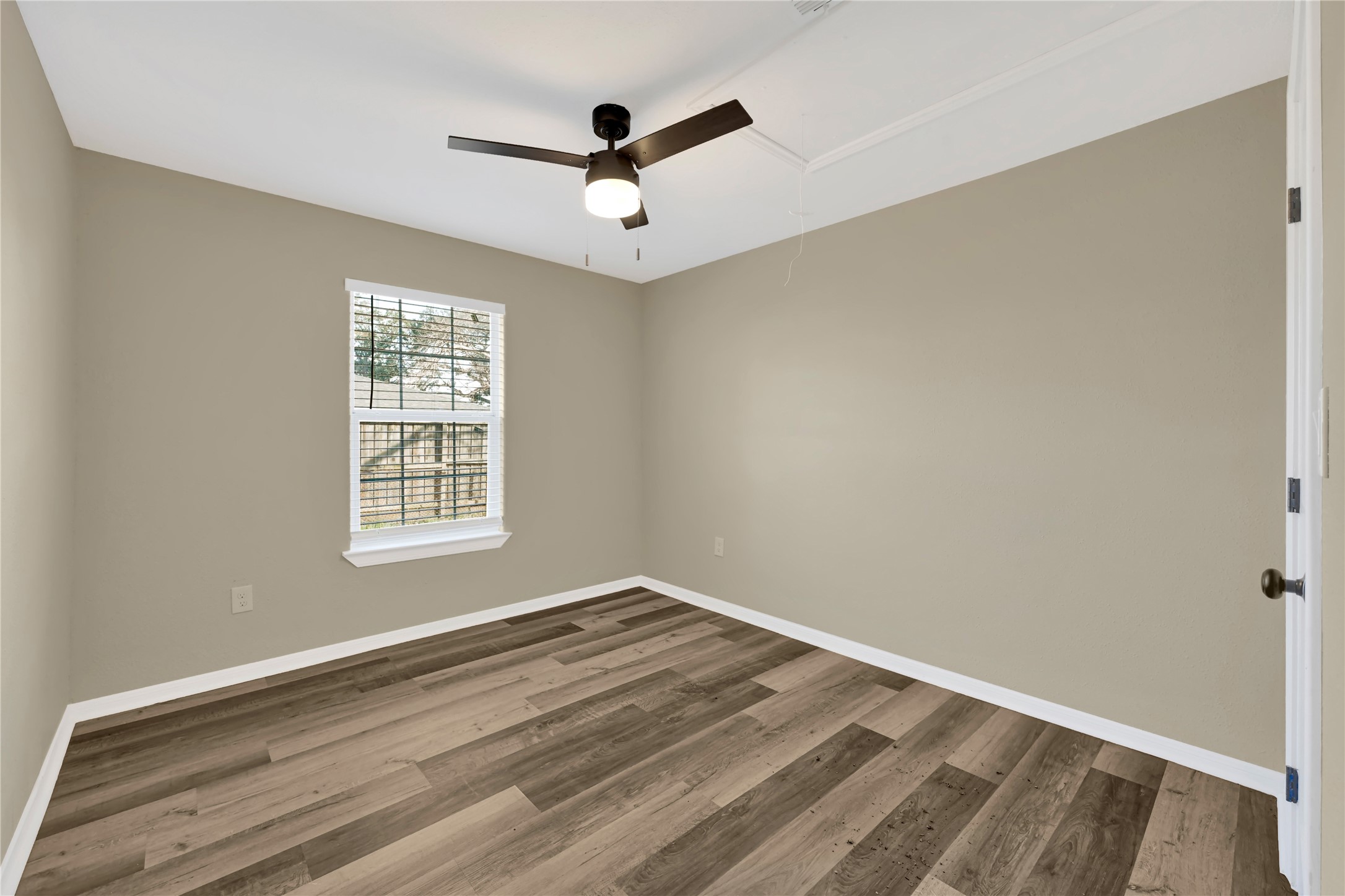 7814 Avenue F Houston, TX 77012 - Photo 27 of 28 a view of a room with a window and a ceiling fan