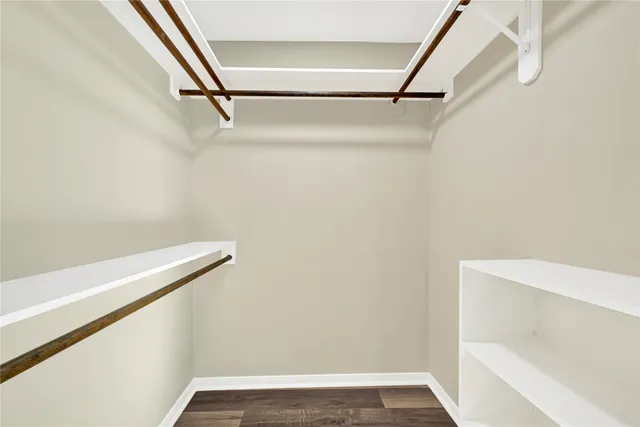 a view of walk in closet with empty racks