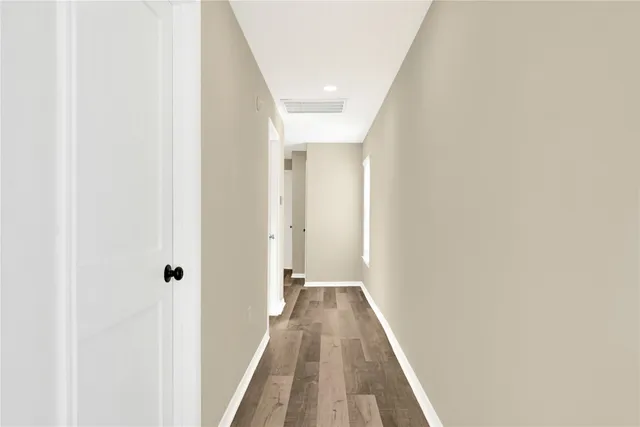 a view of a livingroom with a ceiling fan & a window