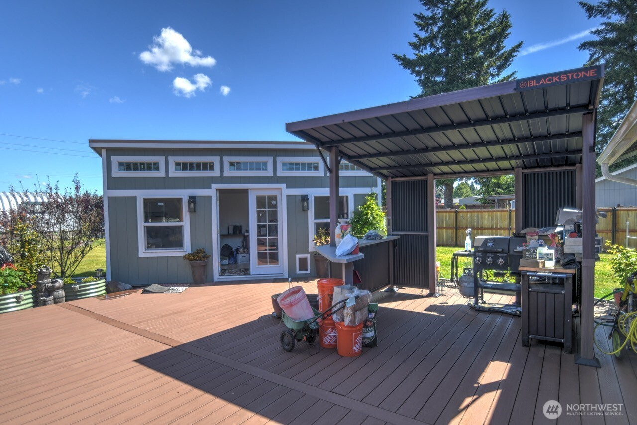 5922 184th Lane Southwest Rochester, WA 98579 - Photo 16 of 34 a view of a patio with table and chairs potted plants with wooden floor and fence