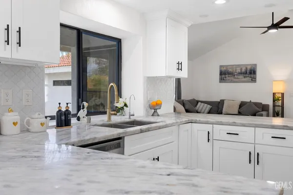 a kitchen with cabinets and window